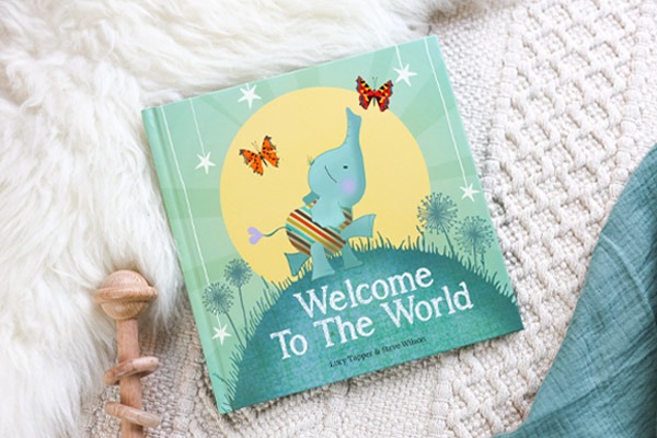 Welcome To The World new baby keepsake book on soft throws. 